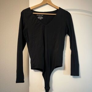 Everlane long-sleeve bodysuit with snap closure.